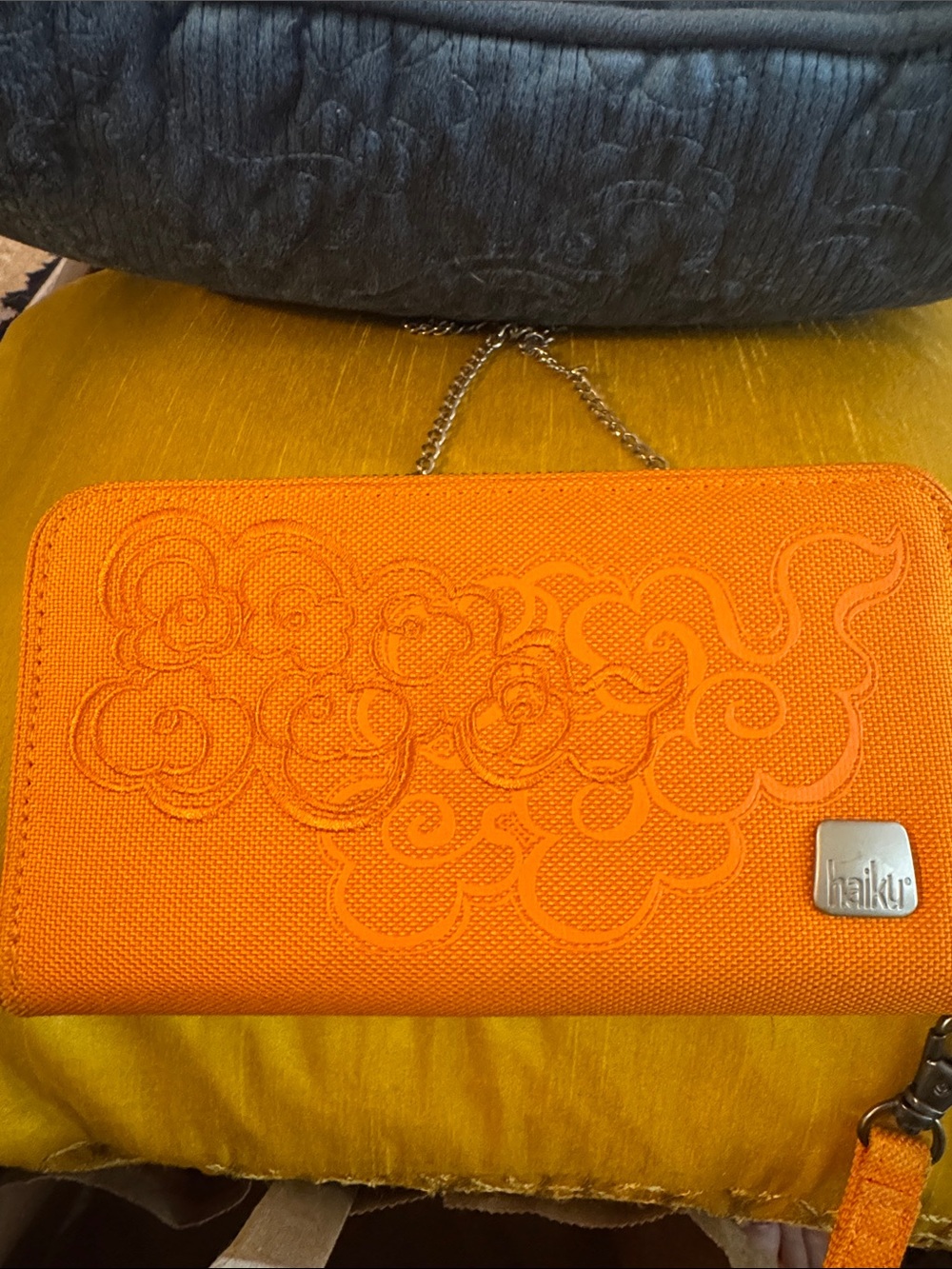Haiku Orange Floral Embossed Wristlet with Chain Strap